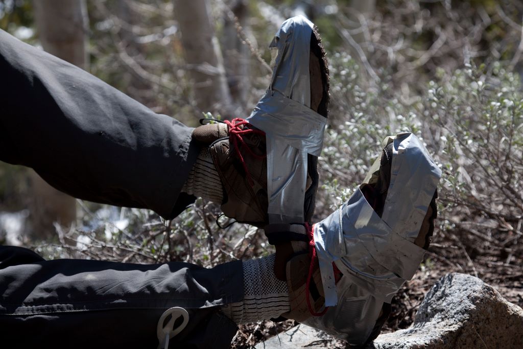 Dale trying to plug the holes in his shoes.  It didn't work.