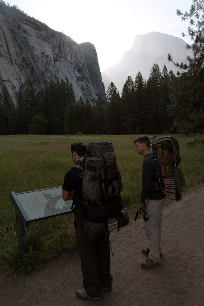 Thomas and Dale read and information board with Half Dome in the background.